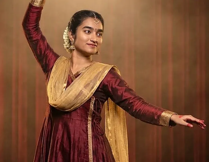 Ashmitha teaching a Kathak position on a video call